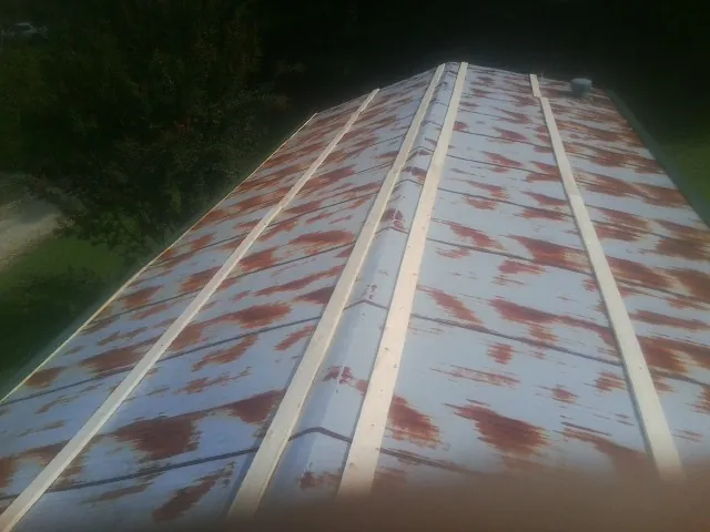 Rusted metal roof panels with new wood purlins before replacement — Storm Damage Roof Repair in Star by Roofing Brothers